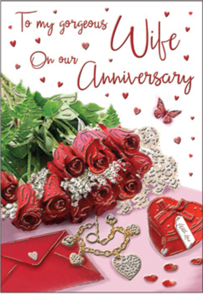 In this richly emotive anniversary scene, a bouquet of classic red roses commands attention, as if it has been placed on a polished surface in an Old Ford home moments before a special celebration. Each bloom is luxuriously full and meticulously shaped, with velvety petals unfurling in densely layered spirals. The roses' deep, confident red is both striking and reassuring, the sort of timeless shade that has accompanied countless love stories across Old Ford. Twined among the flowers is a generous sweep of lush greenery, its lively tones enhancing the sense of natural abundance, like foliage gathered from a walk near Victoria Park. The bouquet rests beside an elegantly scripted card, where graceful lettering curves across the surface amidst delicate heart motifs. Close by, a jewellery set glimmers-a hint of polished metal and gemstones illuminated by soft light-alongside a vivid red box that suggests a treasured keepsake or an anniversary gift waiting to be opened. Wisps of lace or fine fabric run beneath the arrangement, catching light and shadow, adding a romantic softness that contrasts with the glossy surfaces of jewellery and the smooth finish of the envelope. The textures are beautifully varied: velvet-like petals, glossy leaves, cool metallic jewellery, and the subtle grain of the card. Light gathers around the arrangement in a warm halo, giving the impression of late-afternoon sunshine filtering into an Old Ford living room. The atmosphere is openly romantic yet grounded, reflecting years of shared memories-quiet evenings at home, walks by the water, celebrations with close friends-distilled into one thoughtful, visually rich moment captured on this anniversary card.