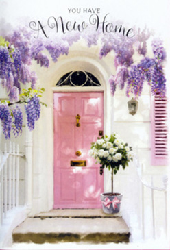 Set against the characterful charm of Old Ford, this image reveals a doorway made tender and inviting through the art of carefully chosen flowers. The front door is painted a soft, powdered pink-calm and muted rather than bright-its smooth finish catching diffuse daylight that might easily have filtered across from the towpath near the River Lea. The door sits within a frame of whitewashed wall, the subtle variations in the paint lending depth and a quiet, almost Mediterranean softness to this East London facade. A delicately painted shutter, in a matching blush shade, balances the composition to one side, hinting at open windows and airy rooms above the canal and cobbled cut-throughs. Above, wisteria twists and tumbles in lavish, lavender-hued trails. Each hanging cluster of flowers-ranging from pale lilac at the edges to a richer violet near the stems-drapes over the doorway like a living curtain, adding movement and a hint of rustic romance. Beneath this floral canopy, resting neatly on the doorstep, a grey tin bucket holds a generous bouquet of white and cream roses. The roses are arranged tightly together, their petals thick and overlapping in luxurious spirals, creating a sense of abundance and care. Fresh green foliage is threaded between the blossoms, adding a crisp, leafy contrast to the soft, creamy tones. Around the bucket, a light pink ribbon is tied in a relaxed bow, trailing gently down and echoing the colour of the door. The whole scene suggests a housewarming gift delivered by a local Old Ford florist, perfect for celebrating a new set of keys and bringing a comforting, floral welcome to a newly claimed home near Roman Road or along the canal.