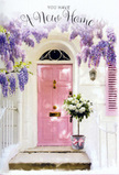 Captured in what could easily be a quiet corner of Old Ford, this image shows a pink-painted doorway turned into a soft celebration of moving in and starting again. The front door is a gentle, chalky pink, its panels catching a wash of natural light that feels as though it could be reflecting off the water by the River Lea or from the green expanse of nearby Victoria Park. Around it, the wall has been whitewashed to a creamy, luminous finish, with just enough texture to catch shadows and add depth. A single shutter, painted in a slightly lighter blush tone, sits to one side and echoes the door's colour, tying the entrance together in a calm, cohesive palette. Above the frame, lush wisteria winds and spills in loose, trailing curtains. Its blooms hang heavily in clusters of pale lilac and lavender, deepening to richer violet near the stems, and they drape across the doorway like nature's own garland. The suggestion of their delicate scent mingles in the imagination with the everyday sounds of Old Ford's streets and canal paths. Settled comfortably at the threshold is a plain grey metal bucket, the sort you might see carried back from an early flower run across East London. Inside, florist-arranged white and cream roses nestle closely together. Each bloom is full and rounded, with velvety petals folding out in intricate spirals, some just opening, others fully unfurled. Slender strands of bright green foliage thread between the flowers, introducing a fresh, leafy contrast. Tied neatly around the bucket's base is a soft pink ribbon, its satin sheen catching the light in gentle highlights and trailing softly across the doorstep. The scene feels like a tender housewarming gesture-perfect for a couple settling into a new Old Ford flat-radiating welcome, optimism, and the promise that this doorway will witness many happy returns home.